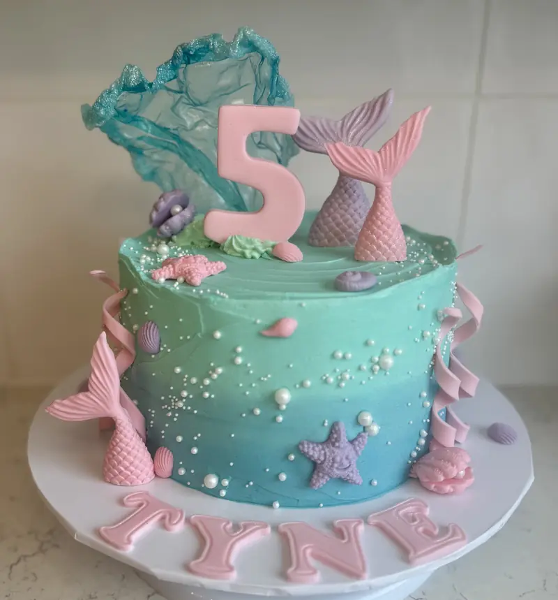 Mermaid-themed birthday cake with colourful buttercream